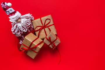 Christmas background with decorations and gift boxes on red background.