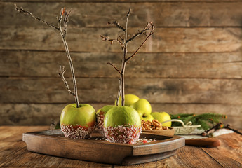 Delicious candy apples on wooden board
