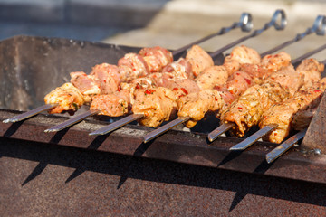 Grilled kebab cooking on metal skewer. Roasted meat cooked at barbecue