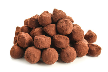 Tasty chocolate truffles on white background