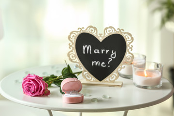 Engagement ring in box on white table indoors