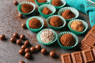 Different tasty chocolate truffles on grey table