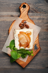 Raw food dessert. Paste from coconut milk, cashew nuts and sugar-free syrup on a cushion of seeds,...
