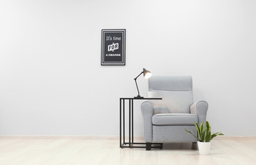 Interior of light room with cozy armchair