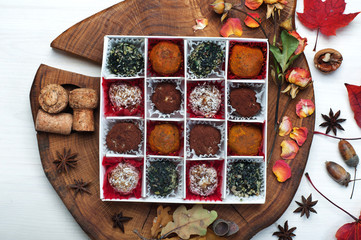 Extra vegan (raw food) sweets from dried fruits, nuts, seeds, spices and seasonings in a white box...