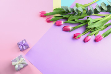 Obraz na płótnie Canvas Beautiful tulips and gifts for Mother's Day on color background