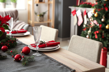 Beautiful table setting with Christmas decorations in living room