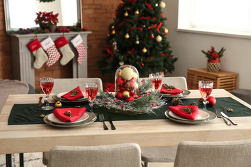 Beautiful table setting with Christmas decorations in living room
