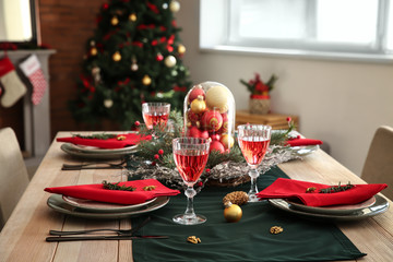 Beautiful table setting with Christmas decorations in living room