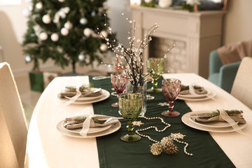 Beautiful table setting with Christmas decorations in living room