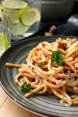 Plate with delicious pasta on wooden table, closeup