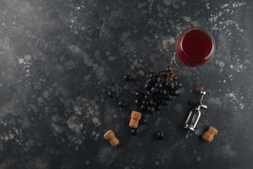 Fototapeta na wymiar Wine top view background. Red wine in a glass goblet with a corkscrew.
