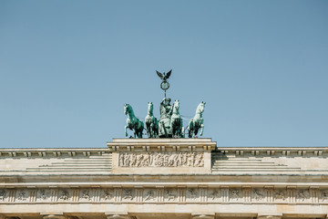 Closeup of the Brandenburg Gate against the blue sky. This is one of the attractions of Berlin in...