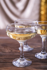 Glasses of champagne on wooden table