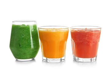 Glasses with tasty fruit smoothies on white background