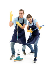 Man and woman having fun with cleaning supplies on white background