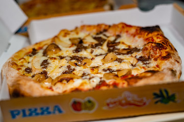 A delicious mushrooms and onion pizza in a box ready to be served