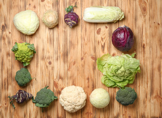 Frame made with different fresh vegetables on wooden table