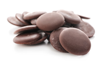Delicious dark chocolate chips on white background
