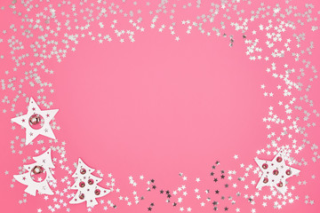 Christmas card. Christmas white and silver decorations on bright pink background. Copy space, top view. Flat lay