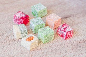 Traditional turkish delight on a wooden table. Assorted Oriental sweets.