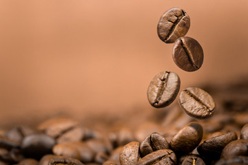 Fototapeta premium Coffee beans falling on pile