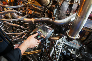Plakat Inspection of a gas turbine engine using a Video Endoscope. Search for defects inside the turbine and shooting on video, photos using a measuring instrument.