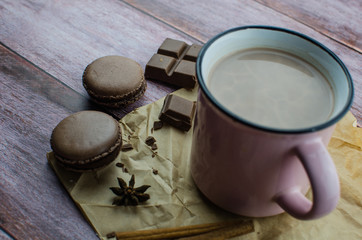 Cocoa drink with spices, zephyr on wooden background