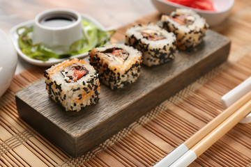 Tasty sushi on wooden stand