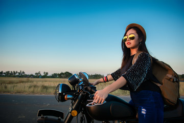 Fototapeta na wymiar Young woman drive with motorbike on street, enjoying freedom and active lifestyle, having fun on a bikers tour.