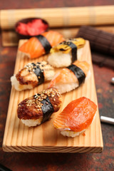 Tasty sushi on wooden stand