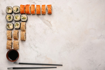 Composition with tasty sushi on light background