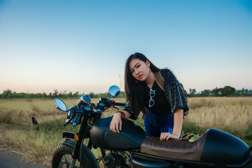 Fototapeta na wymiar Young woman drive with motorbike on street, enjoying freedom and active lifestyle, having fun on a bikers tour.