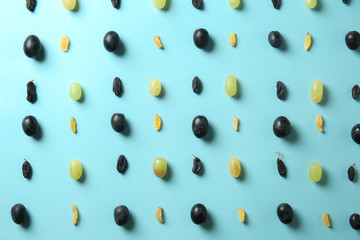 Grapes with raisins on color background