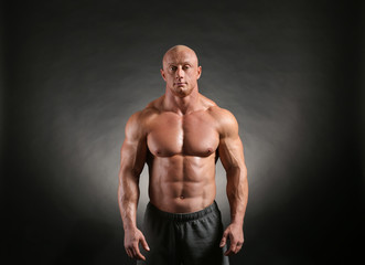 Fototapeta premium Muscular bodybuilder on dark background