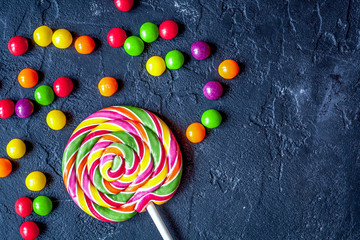 sweets and sugar candies on dark background top view