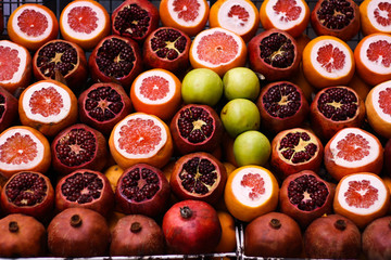 Many ripe juicy fruits - grapefruits, apples, pomegranates
