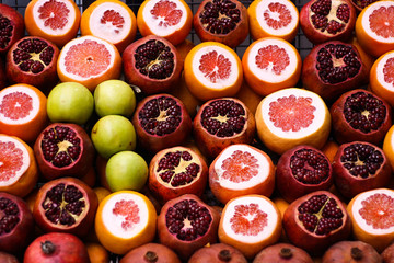 Many ripe juicy fruits - grapefruits, apples, pomegranates