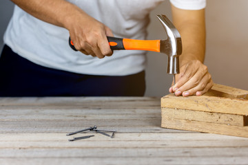 Carpenter man hammering a nail
