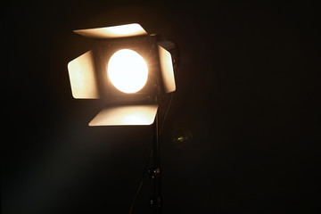 Fototapeta na wymiar Professional lighting equipment on dark background