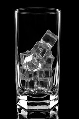 glass with ice cubes on black background