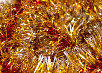 Colorful Christmas tinsel. New year's fluffy gold tinsel, and pink tinsel. Sparkling ornament decoration concept.