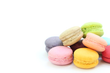 Fototapeta na wymiar Close up many colorful fresh macarons pile isolated on white background, look delicious, have copyspace