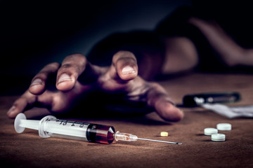 Addict man grab drug syringe