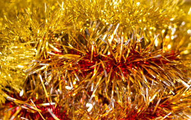 Colorful Christmas tinsel. New year's fluffy gold tinsel, and pink tinsel. Sparkling ornament decoration concept.