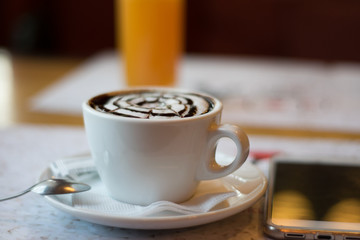still life with a cup of flavored cappuccino, a phone on the background of a glass of orange juice. wallpaper