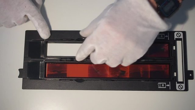 Removing the film from the frame of the scanner. Home office in a viral infection. Adaptation of society to social distance.