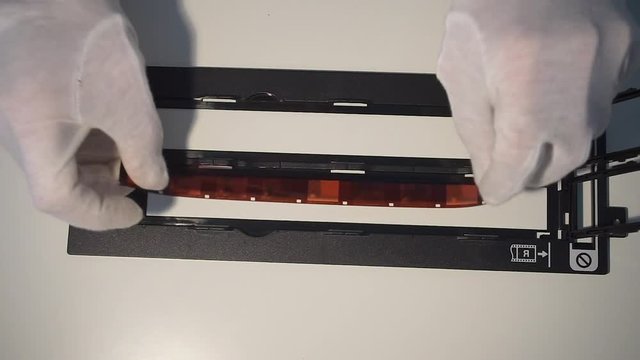 Preparing a narrow film for scanning close-up. Home office in a viral infection. Adaptation of society to social distance.