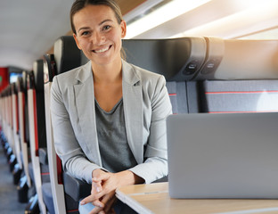 Businesswoman smiling on train
