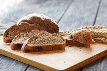sliced bread with wheat ears on a wooden table